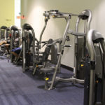 Students exercise on gym equipment