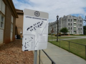 Upper residence quad sign with dorms behind