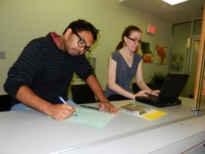 Two staff work at a desk